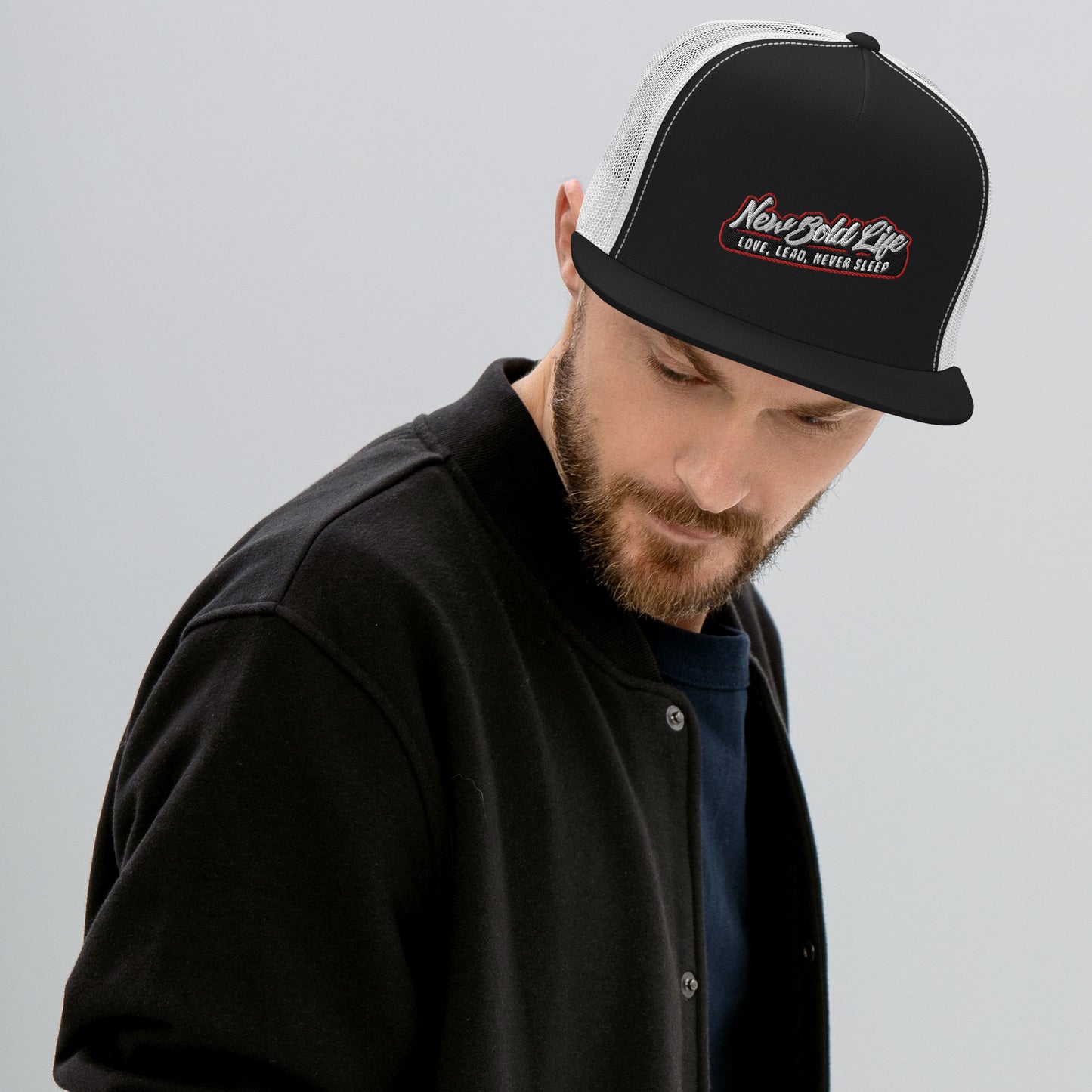 Image of model wearing New Bold Life Trucker Cap - Hats. The cap is black and white with the Newboldlife logo on the front.