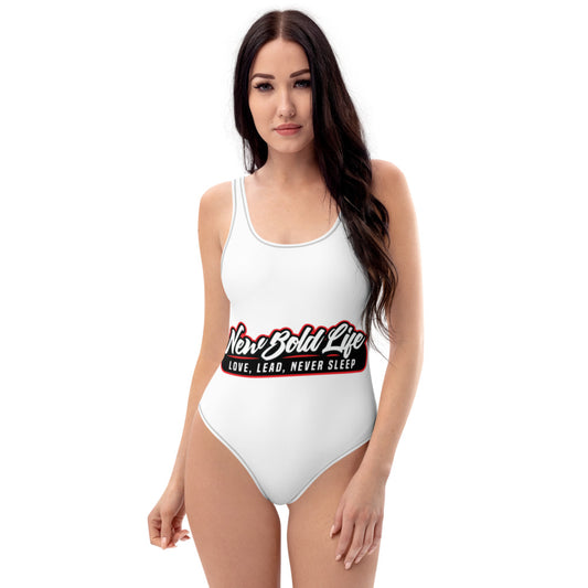 Model wearing a New Bold Life One-Piece Swimsuit - Women's Apparel. Swimsuit is all white with large Newboldlife logo center.