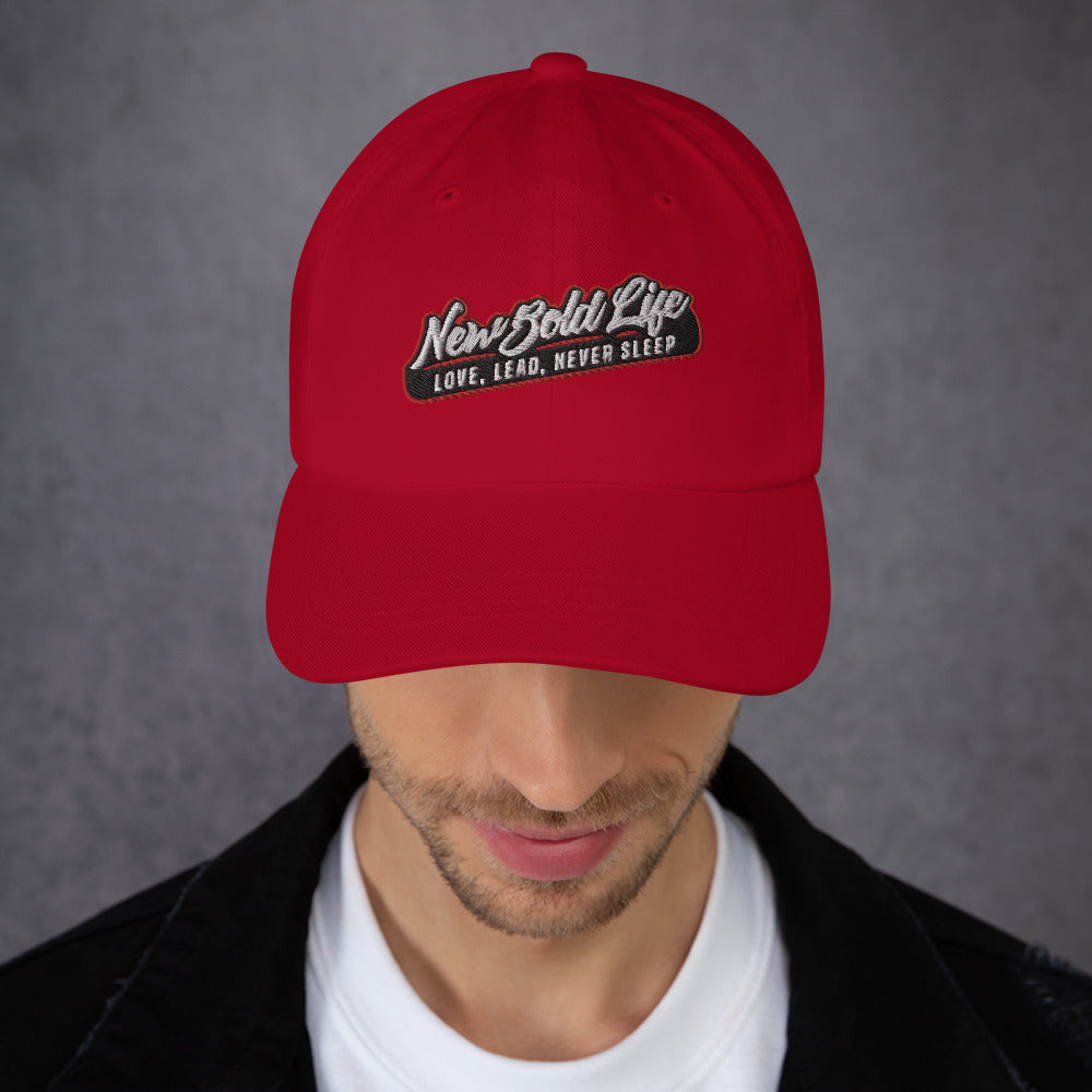 Image of model wearing New Bold Life Signature Baseball Caps - Hats. Cranbery color with Newboldlife logo on the front.