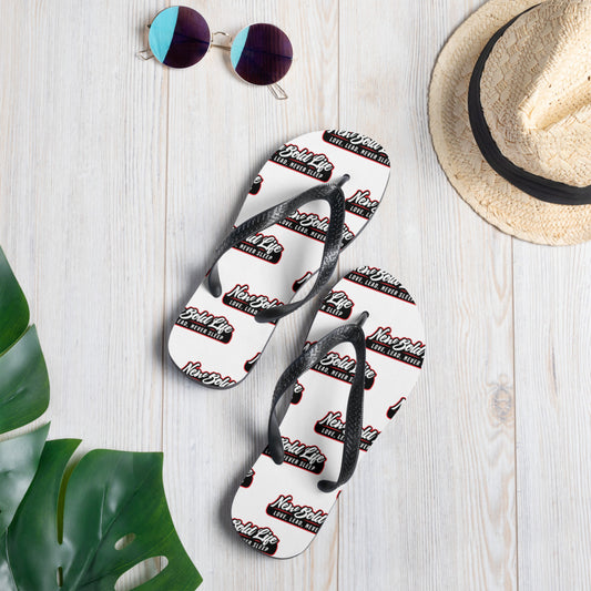 Photo of a pair of New Bold Life Flip-Flops - Accessories. The sandals are white with black straps and newboldlife logo printed all over.