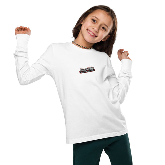 Young model wearing a white New Bold Life Youth long sleeve tee - Kid's Clothing. Newboldlife logo on center of chest.